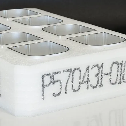 Large-character codes printed by the EBS-1600 on white plastic crates