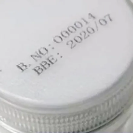 Batch number and best-before date printed on a plastic bottle cap