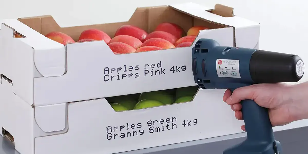 Handheld printer marking a code onto corrugated board